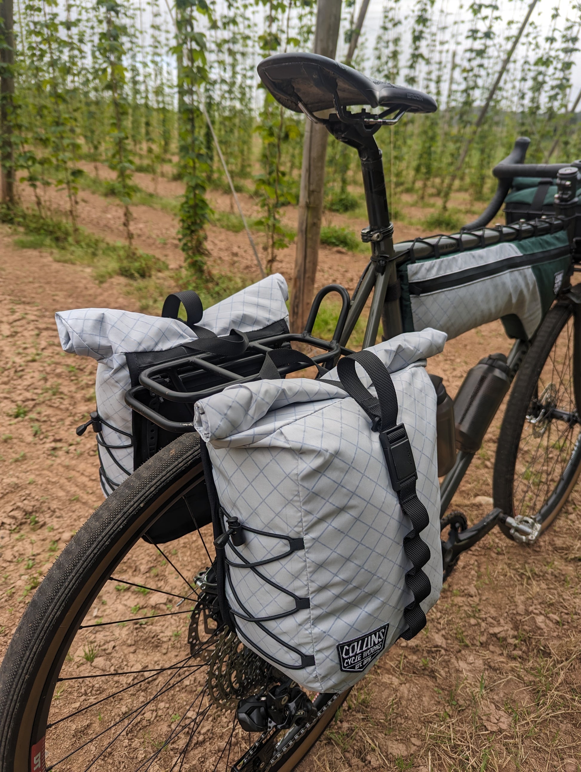 Bicycle with cargo bags on a dirt path in a forest